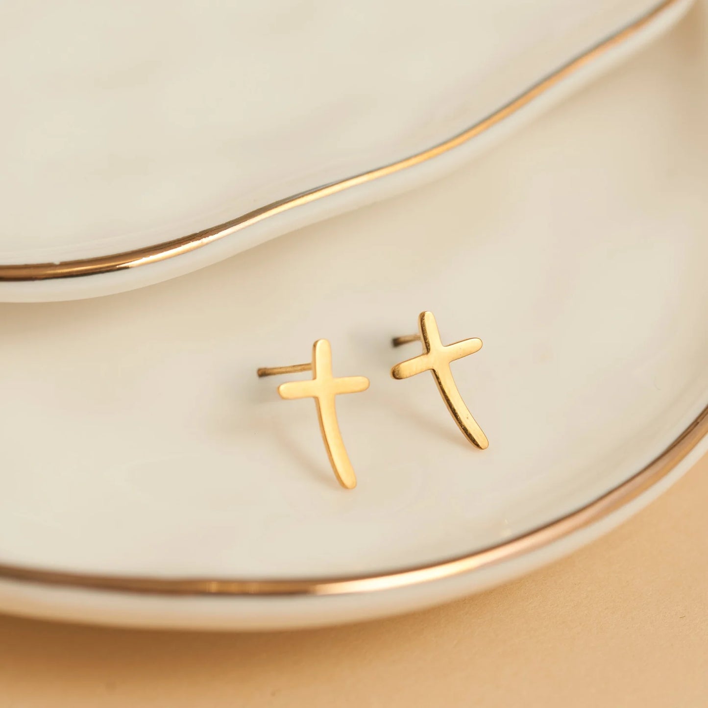 Gold curved cross earring