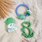 Itzy Mitt™ Silicone Teething Mitts: Dinosaur